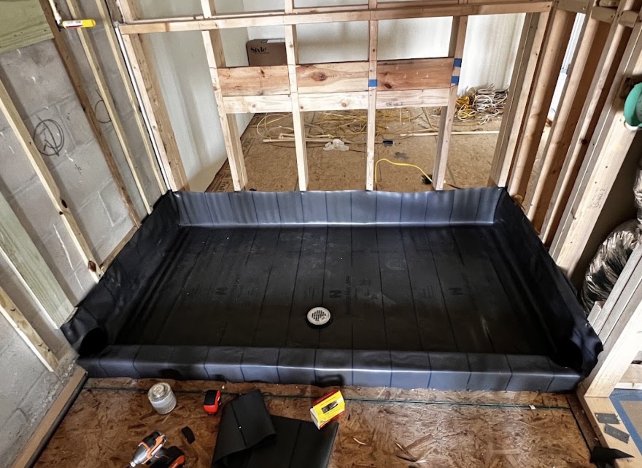 Shower pan plumbing installation in progress